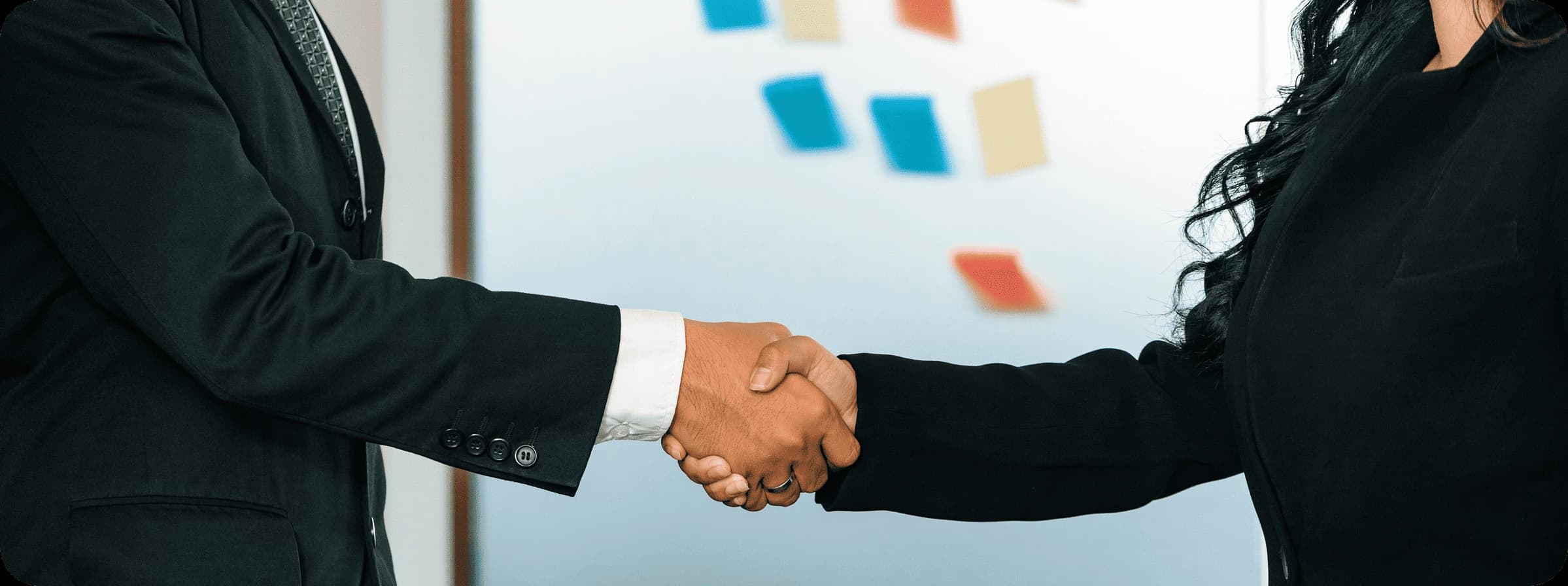 Aliados de negocio estrechando las manos como cierre de una colaboración estratégica